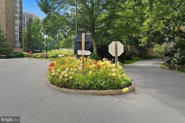 view of road with curbs and traffic signs