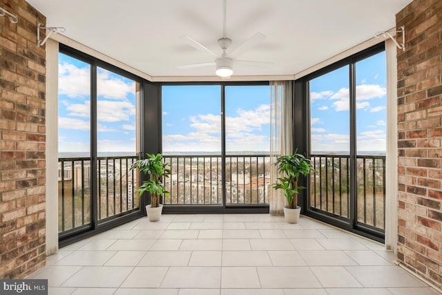 unfurnished sunroom featuring a ceiling fan