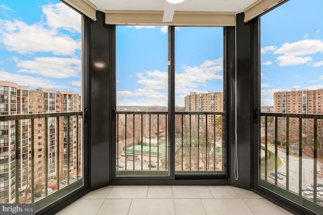 unfurnished sunroom featuring a view of city