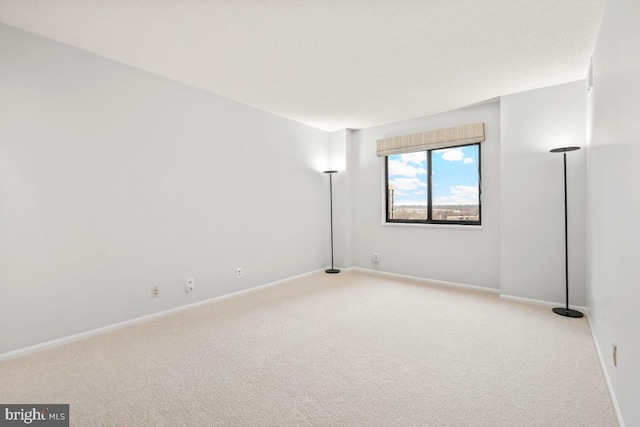 spare room with carpet floors and baseboards