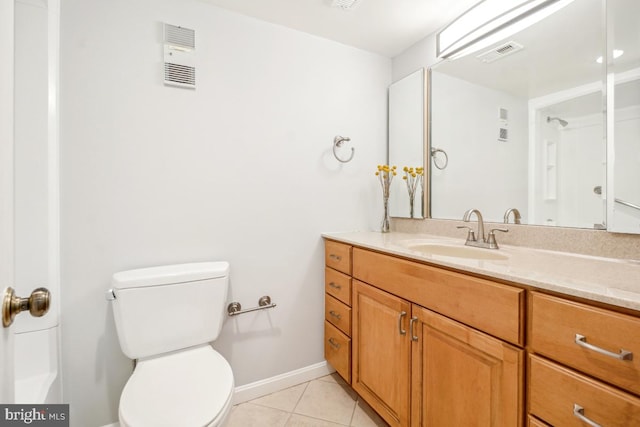 bathroom featuring visible vents, toilet, vanity, tile patterned flooring, and baseboards