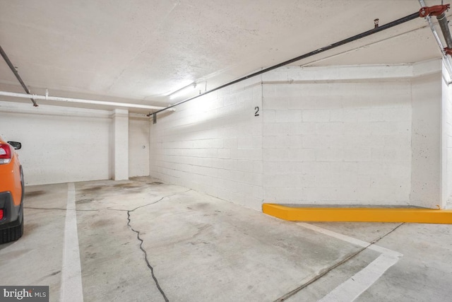 parking garage featuring concrete block wall