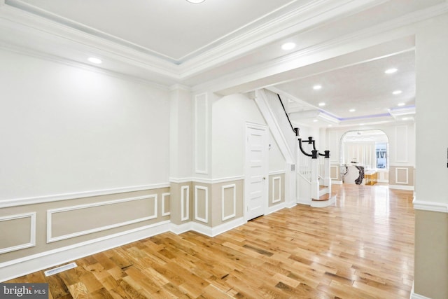 interior space with hardwood / wood-style floors and ornamental molding