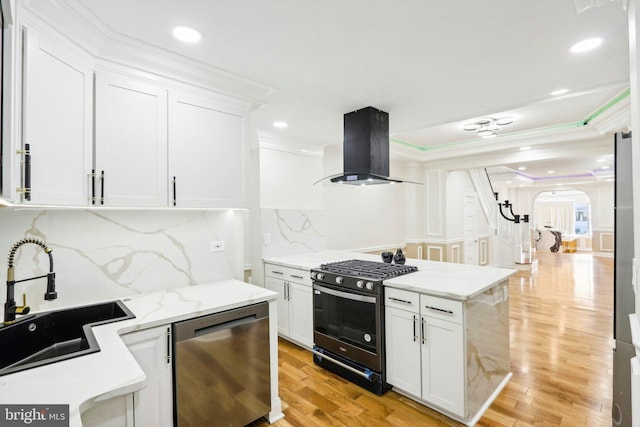 kitchen featuring light wood-type flooring, stainless steel dishwasher, extractor fan, white cabinets, and black gas stove