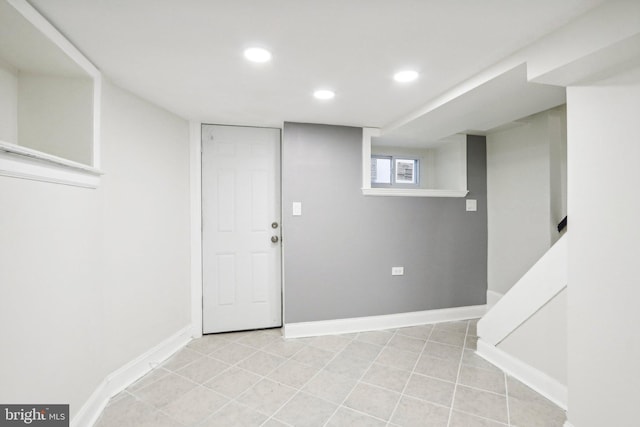 basement with light tile patterned flooring