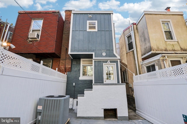 view of front of property with central AC unit and cooling unit