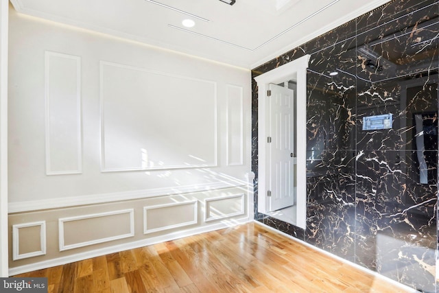 interior space featuring hardwood / wood-style floors and crown molding