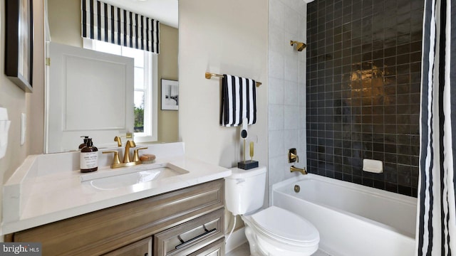 full bathroom featuring shower / bath combo with shower curtain, vanity, and toilet