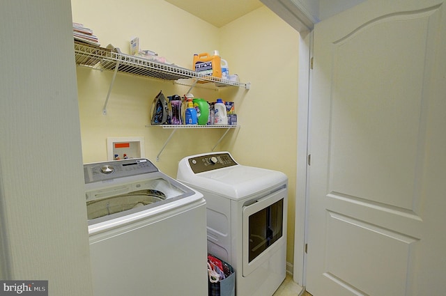 clothes washing area featuring washer and clothes dryer