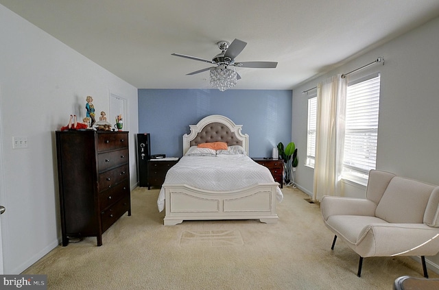 bedroom with ceiling fan and light carpet