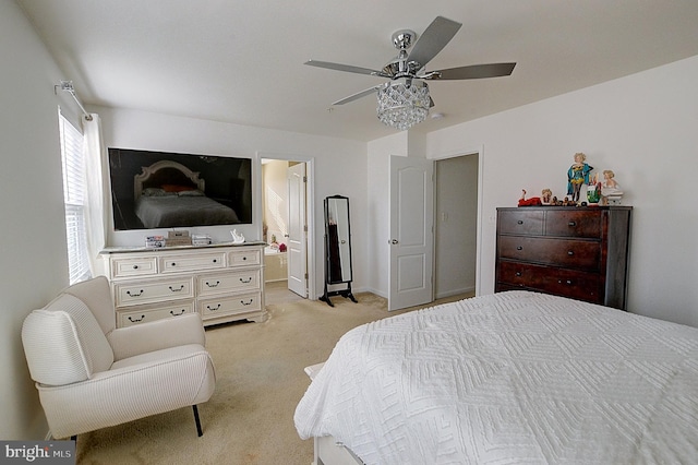 carpeted bedroom with connected bathroom and ceiling fan