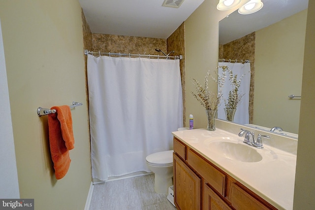 bathroom with vanity, toilet, and curtained shower