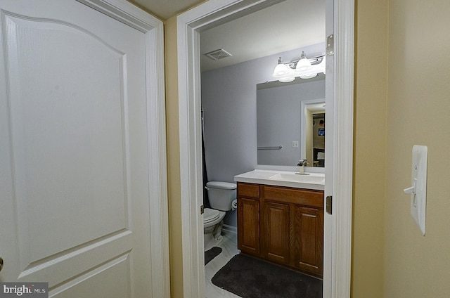 bathroom with vanity and toilet