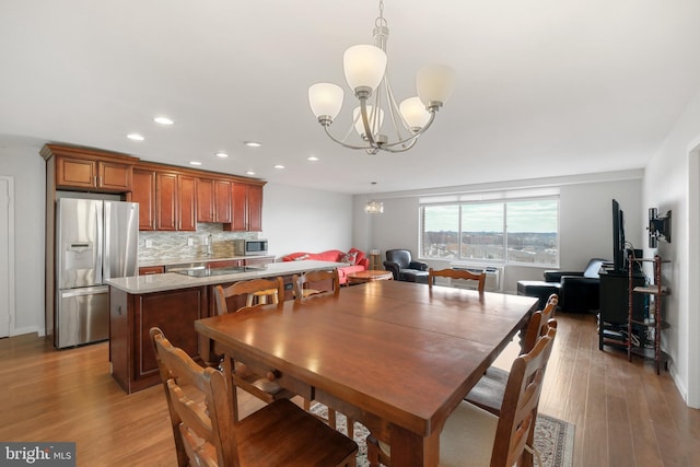 dining room featuring hardwood / wood-style flooring and an inviting chandelier