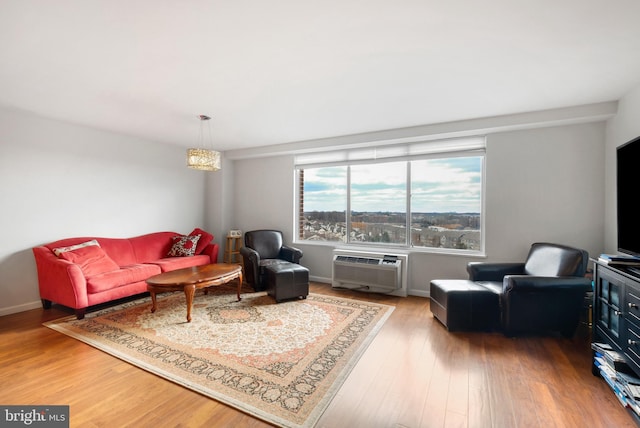 living room with hardwood / wood-style flooring and a wall mounted AC