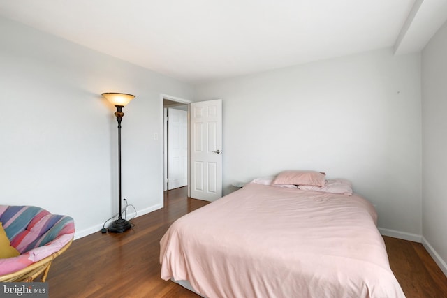 bedroom with dark hardwood / wood-style flooring