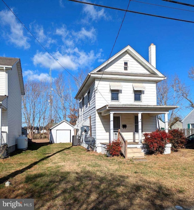 view of front of property featuring central AC, a garage, an outdoor structure, and a front lawn