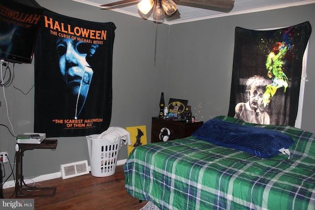 bedroom featuring wood-type flooring, ceiling fan, and ornamental molding