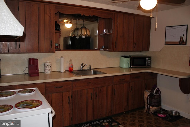 kitchen with tasteful backsplash, ceiling fan, sink, and extractor fan