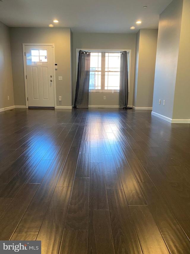 entryway with dark hardwood / wood-style floors