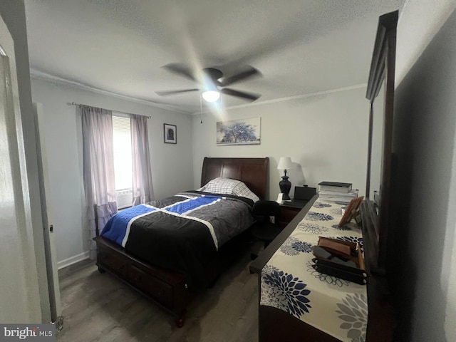 bedroom featuring ceiling fan, hardwood / wood-style floors, crown molding, and a textured ceiling