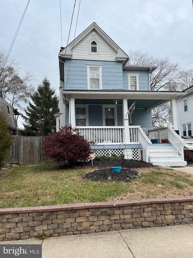 view of front of house with a porch and a front lawn