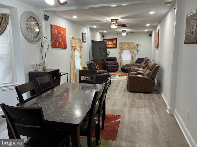 dining space featuring light wood-type flooring and ceiling fan