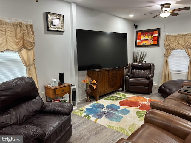 living room featuring light hardwood / wood-style flooring and ceiling fan