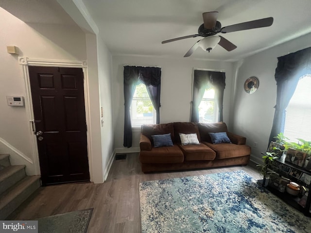 living room featuring hardwood / wood-style flooring and ceiling fan