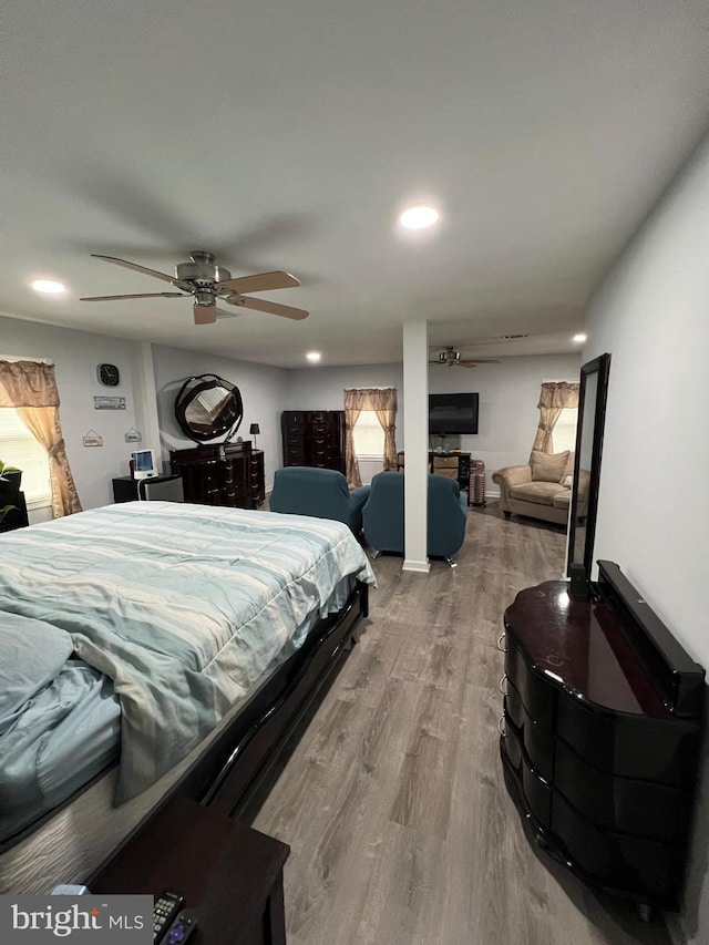 bedroom with ceiling fan and hardwood / wood-style floors