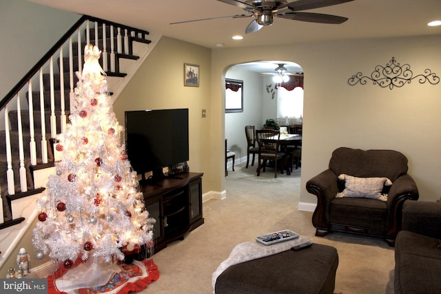 living room with ceiling fan and light colored carpet