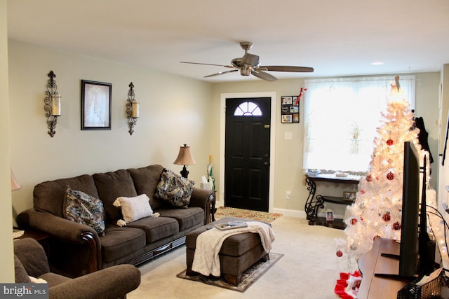 carpeted living room featuring ceiling fan