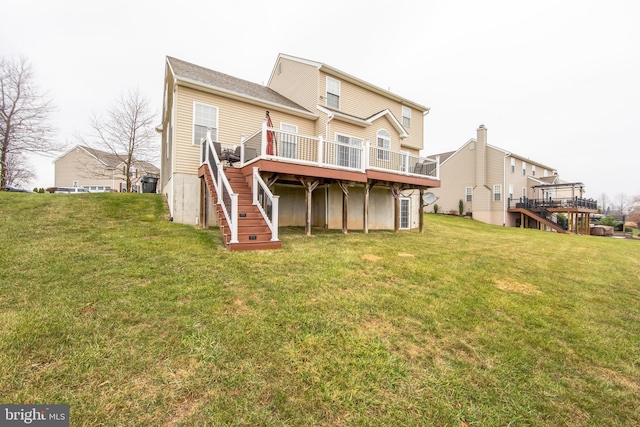 back of house featuring a wooden deck and a yard