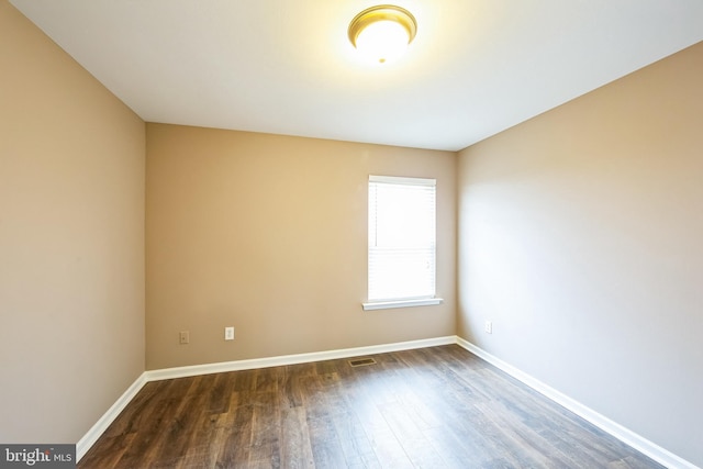 spare room with dark hardwood / wood-style floors