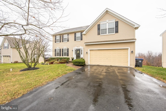 view of front of property with a front lawn and a garage