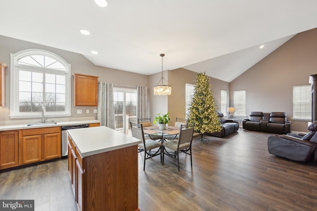 kitchen featuring pendant lighting, dishwasher, sink, dark hardwood / wood-style floors, and a kitchen island