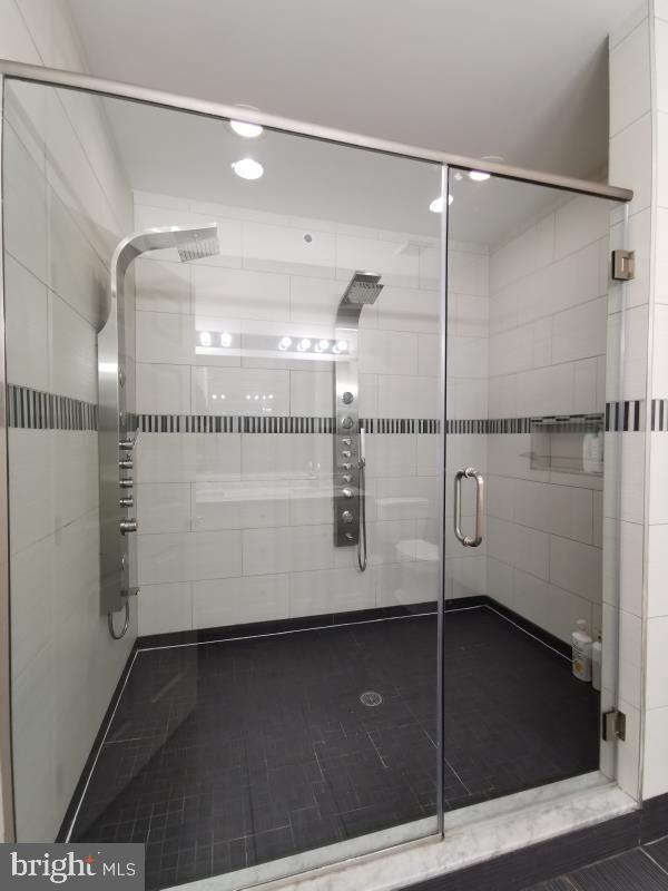 bathroom featuring tile patterned flooring and a shower with door