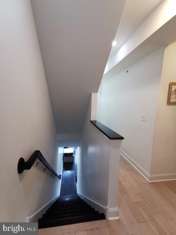 stairs with wood-type flooring