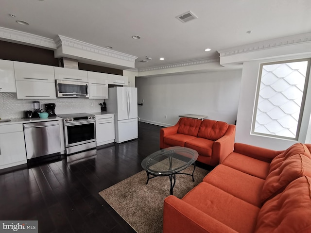 living room featuring dark hardwood / wood-style floors and crown molding