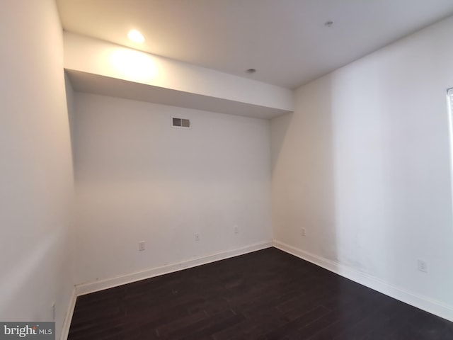 basement with dark hardwood / wood-style flooring