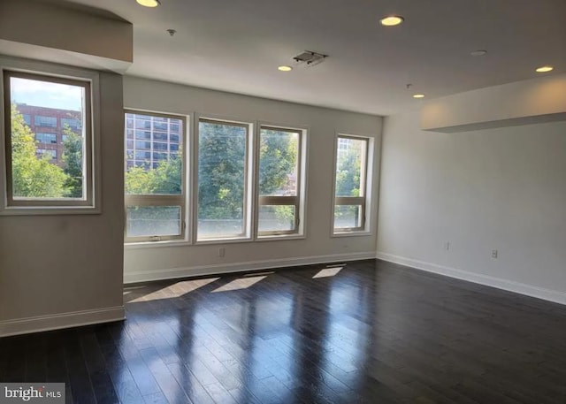 unfurnished room featuring dark wood-type flooring