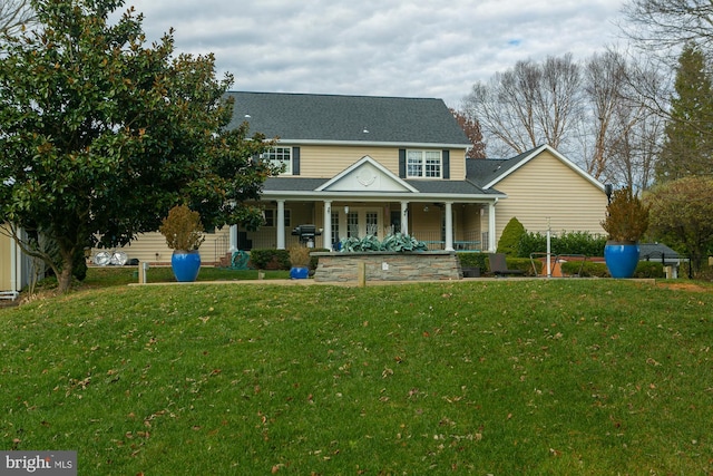 view of front of home featuring a front yard and covered porch