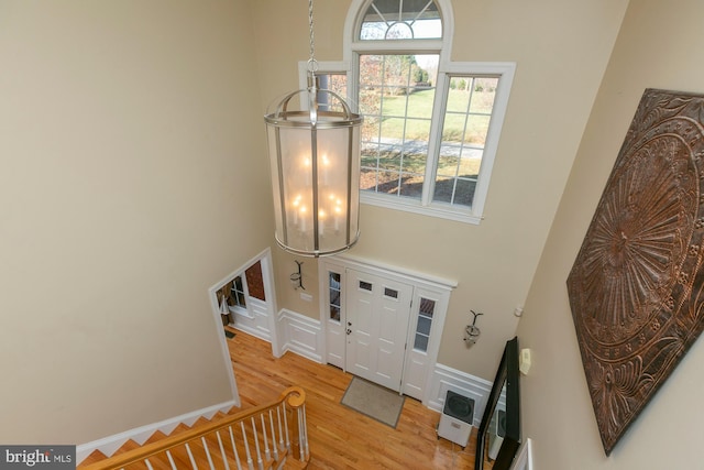 entryway featuring light hardwood / wood-style floors and a high ceiling