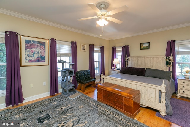 bedroom featuring multiple windows, crown molding, ceiling fan, and light hardwood / wood-style floors