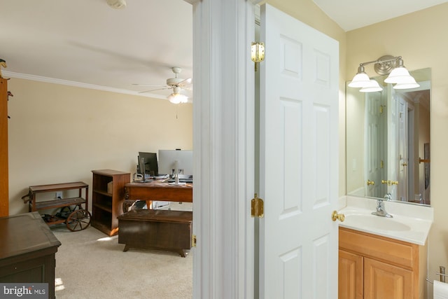 bathroom with crown molding, ceiling fan, and vanity