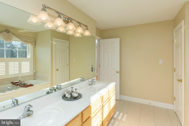 bathroom with vanity, tile patterned flooring, and a tub