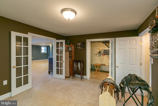 interior space with light carpet and french doors