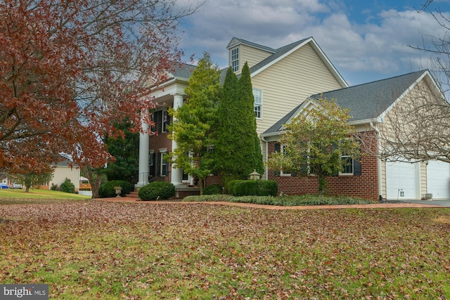 view of front of property with a garage and a front lawn