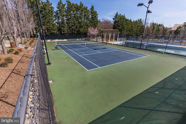 view of sport court with basketball hoop