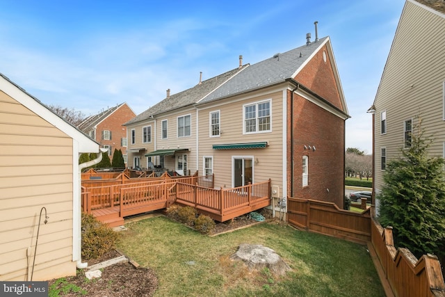 back of house with a lawn and a deck